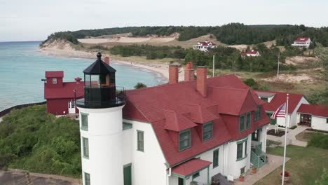 historic point betsie lighthouse in frankfort, michigan located along lake michigan with drone video close up moving in.