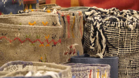 different kinds of woven persian carpets for sale on marrakesh bazaar stall, close up