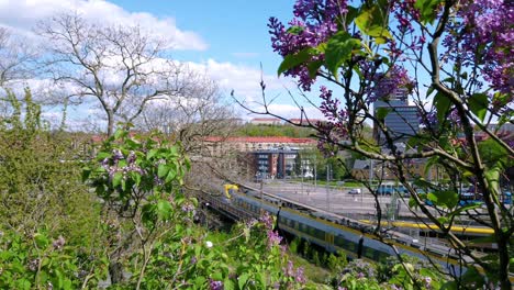 Passenger-train-passing-on-railroad-tracks-in-Gothenburg,-high-angle