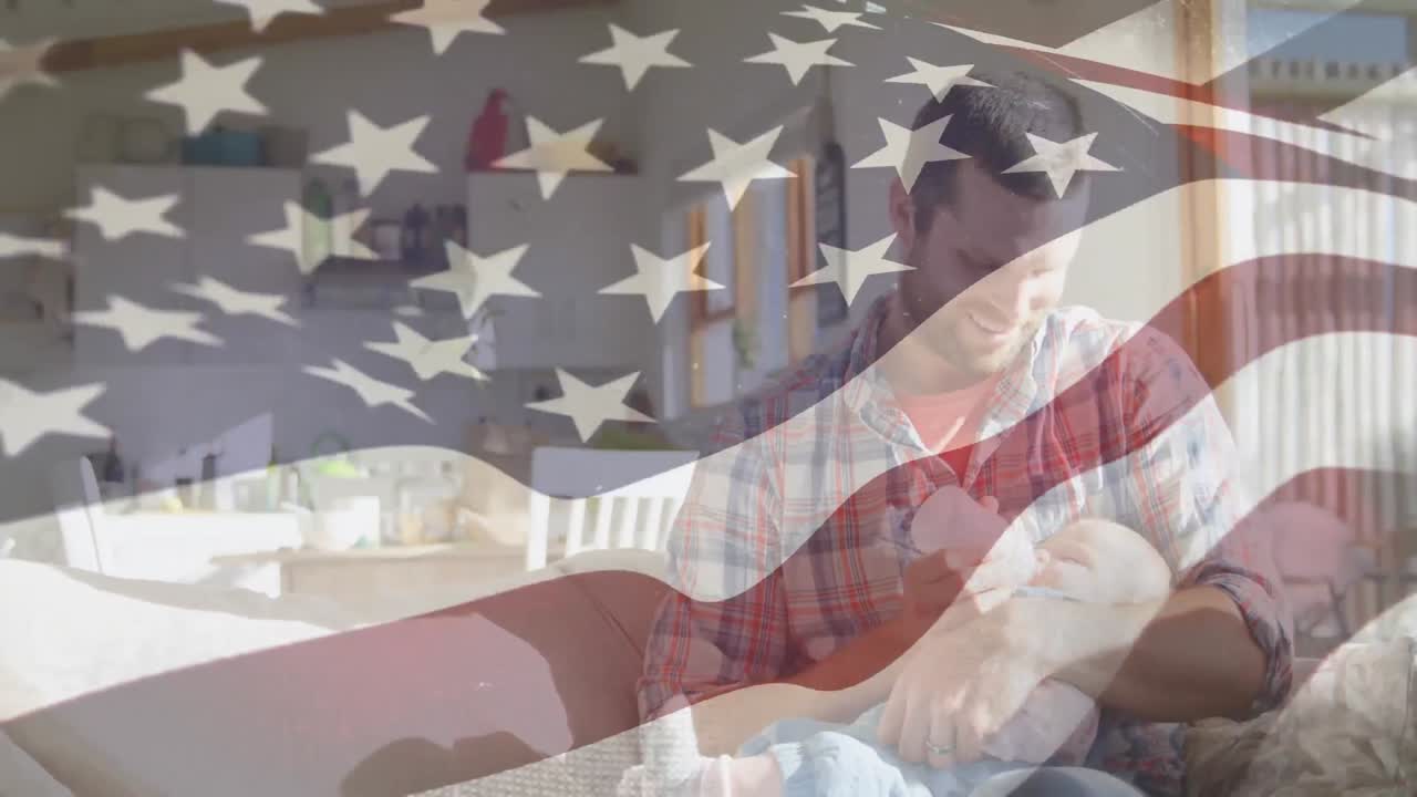 кавказский отец кормит ребенка с нами флаг размахивает на переднем плане