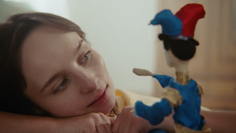 a girl playing with dolls in her room