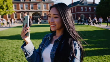 young woman taking a selfie on university campus