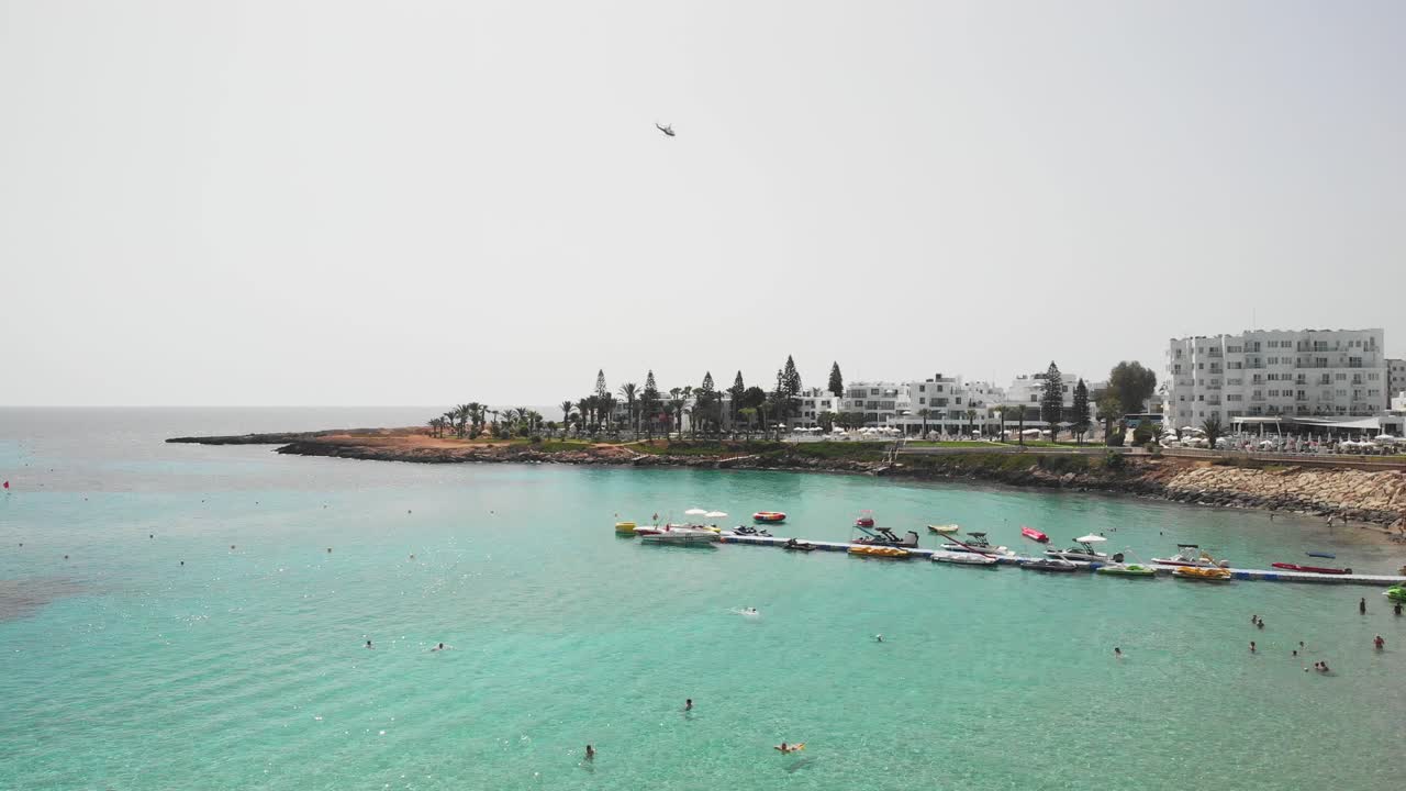 Helicopter flying above Protaras city. Aerial drone shot. Cyprus
