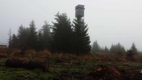 A-drone-flies-toward-an-observation-tower-shrouded-in-mist-in-Belgium