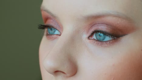 close-up makeup application on a woman with blue eyes