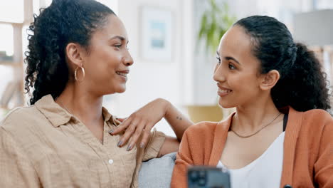 Lesbian-couple,-phone-and-home-sofa-together-to