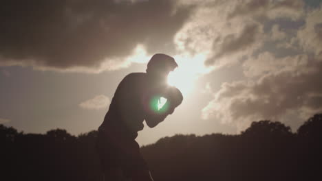 Man-Boxing-In-The-Park-With-The-Sun-Behind-Him-In-Slow-Motion