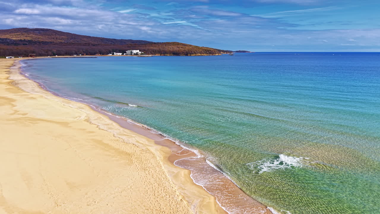 Stunning shoreline view at a tranquil beach during a sunny day in autumn capturing the essence of nature's beauty