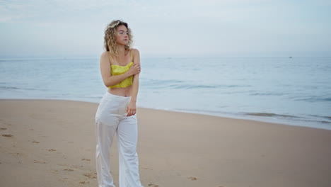 girl dancer walking beach making slowly smooth movements. woman stepping sand