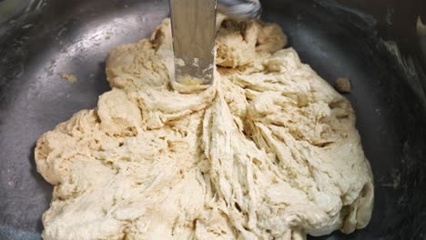 dough being mixed in a commercial mixer