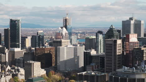 a warm autumn sun bathes montreal's downtown cityscape with a new skyscraper rising amidst the established high-rises