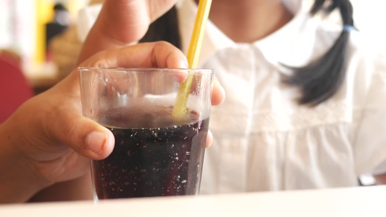Child drinking soda at a restaurant