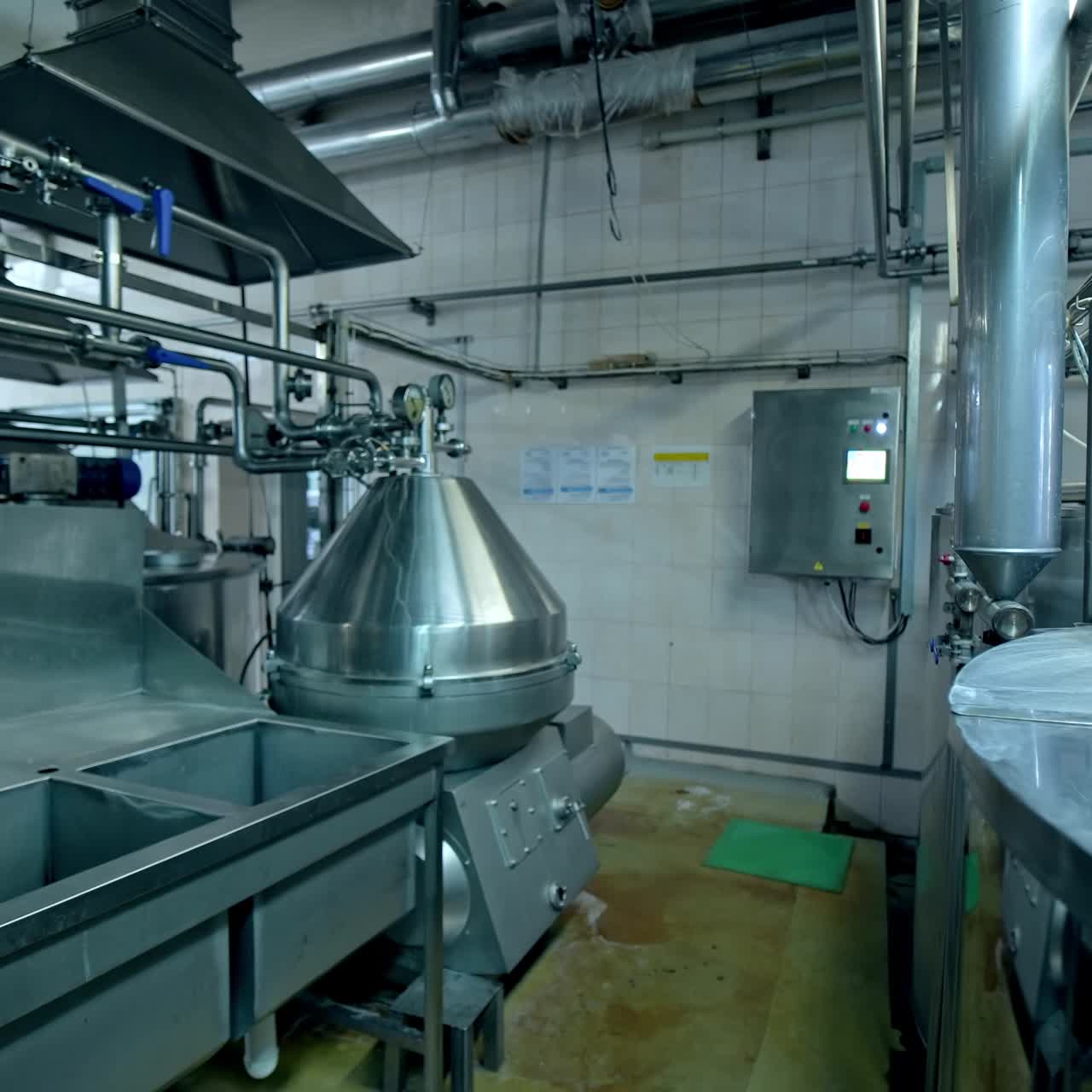 Dairy factory. Metal equipment with industrial pipes for milk processing indoors. Automated technology on a milk farm