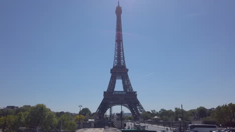 eiffel tower, vertical dolly pan from a big sculpture of trocadero gardens