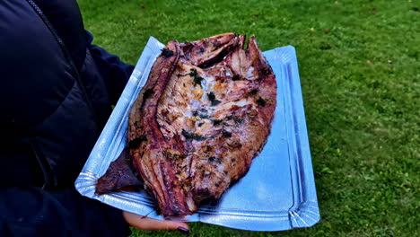 grilled fish on a silver tray outdoors