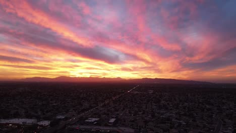 stunning aerial sunset over city and mountains
