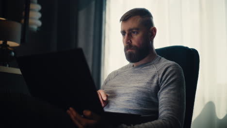 financial expert working on laptop, monitoring real-time stocks and exchange market charts, making investments. successful businessman works in comfortable office of investment bank. dolly shot.