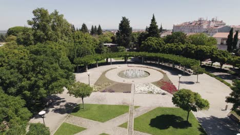 aerial circular view of gushing fountain in elegant garden