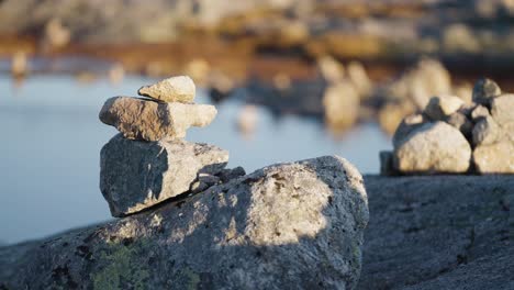 a close-up shot of the small stone cairns on the top of the big boulder