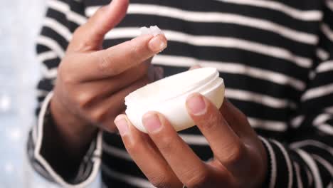 applying cream from a container