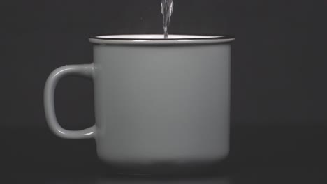 filling cup with hot water with vapour, slow motion 4k