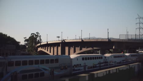 drone shot of a los angeles metro train going on a bridge over the la river in los angeles, california