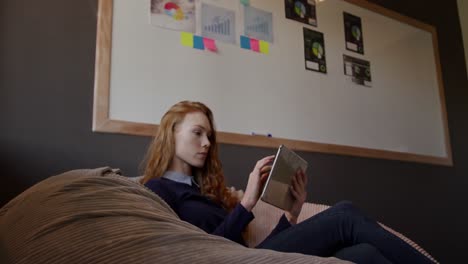 caucasian woman using computer tablet in creative office