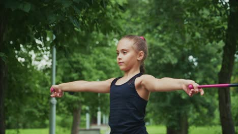 focused young athlete engages in physical training outdoors, embracing strength and determination amidst lush greenery for a healthier lifestyle