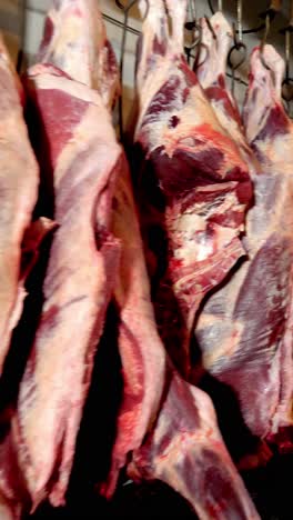 raw beef carcasses hanging