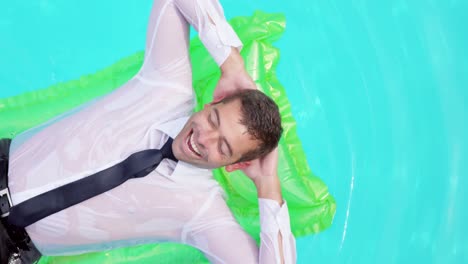 Businessman-lying-on-lilo-