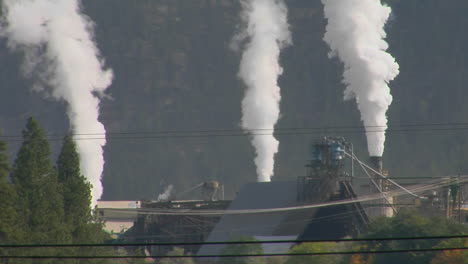 Smoke-Billows-Out-Of-Three-Stacks-Of-A-Factory