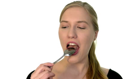 licking a teaspoon