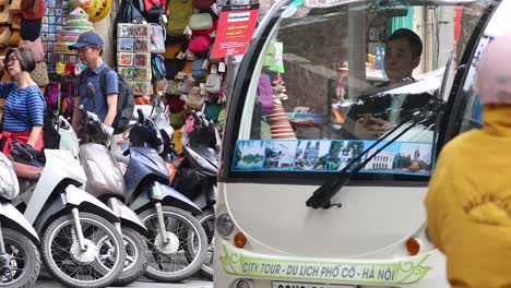 busy street with motorbikes and people