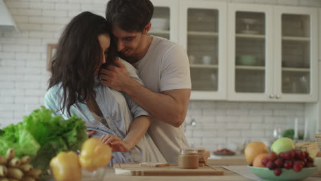 Lovely-couple-flirting-at-home.-Sensual-woman-flirting-with-man-at-kitchen