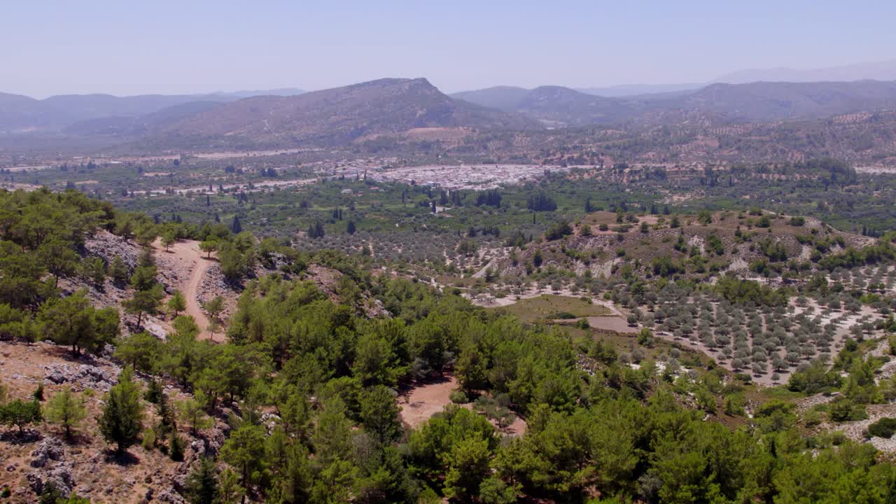 Aerial shot of Rhodes’ mountainous terrain covered with trees