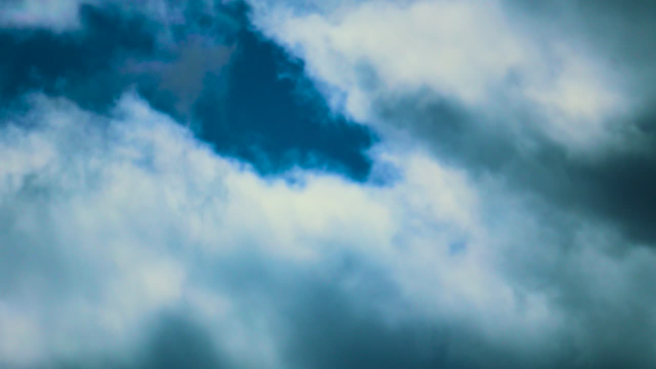 Slow Moving Timelapse of Light and Dark Clouds Moving Across the Sky. Natural Background Wallpaper Copy Space.