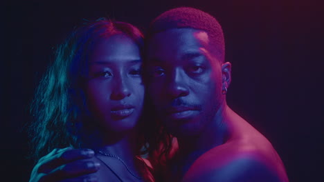 young romantic couple under colorful neon lights