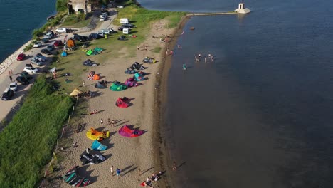 wind and kite surfers camping on the beach of neretva valley - aerial drone view