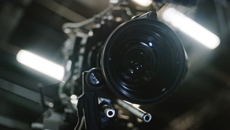 low angle shot of a professional cinema camera and long telephoto zoom lens, focus motor is turning the gears and the lens element is moving to change focus distance