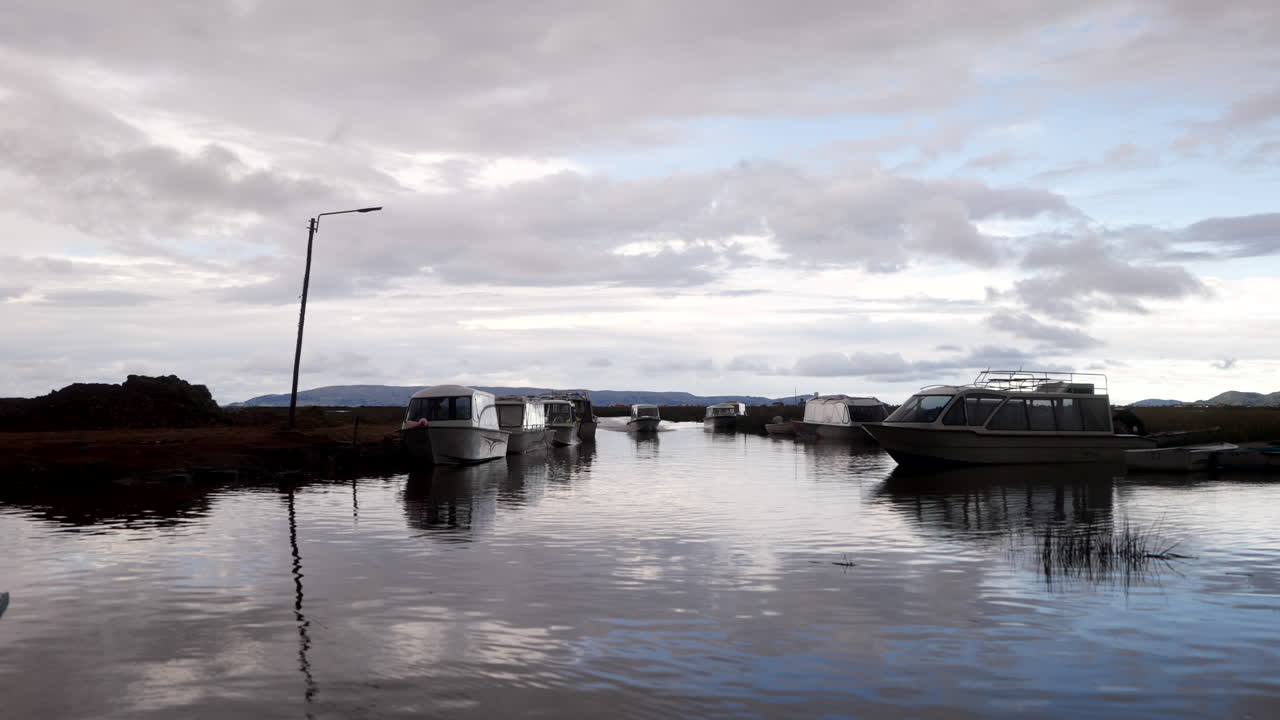 Speedboat Cruising on Lake Titicaca At Dusk In Uros Floating Islands In Peru. - handheld shot