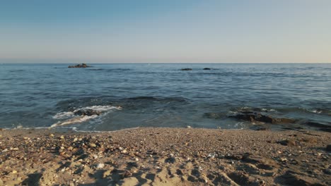 Slowly-moving-horizontally-at-a-rocky-beach