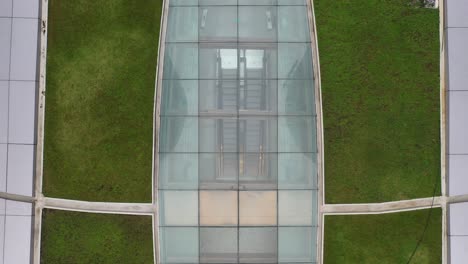 aerial view of modern twin towers with rooftop garden and glass bridge