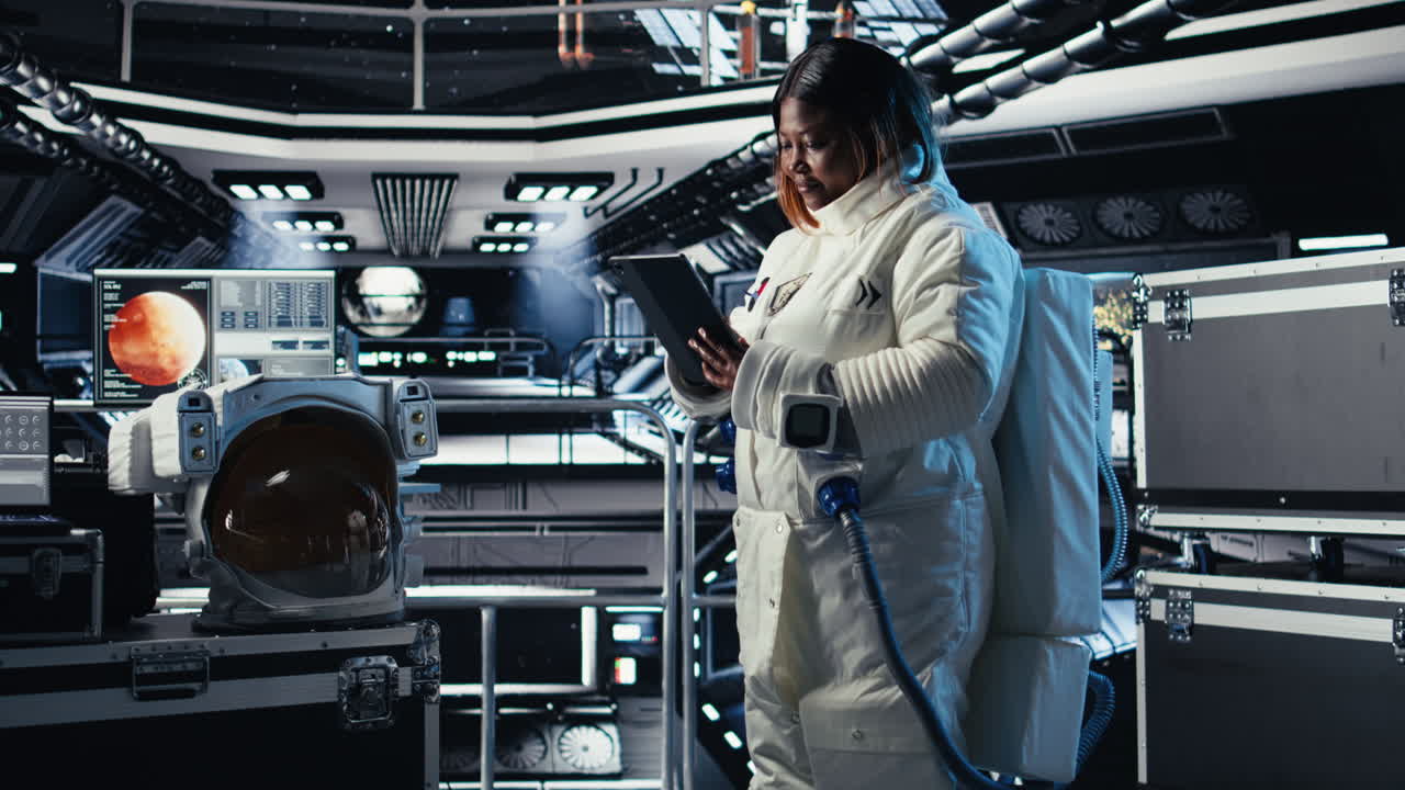 Astronaut in spacesuit checks human expansion in space mission data on tablet
