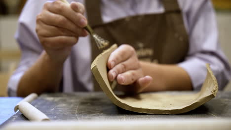 close-up of someone working on pottery project