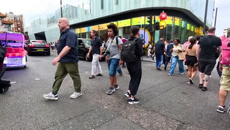 crowded intersection with people and vehicles