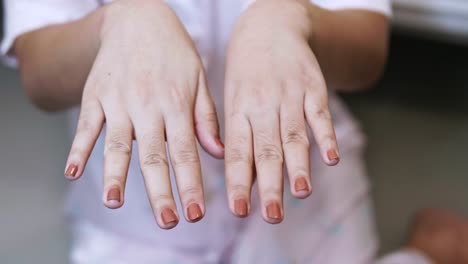 closeup of a woman paints her nails by self made manicure at home slow motion scene