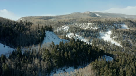 Aerial-view-of-steep-mountain-highway-switchbacks-in-winter