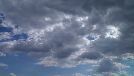 Fluffy-white-clouds-drifting-across-a-clear-blue-sky