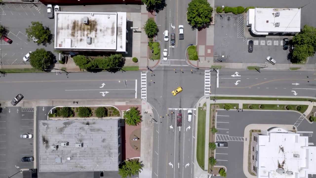 Traffic intersection in downtown Statesville, North Carolina with drone video overhead.