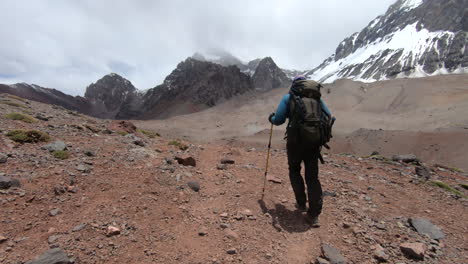 Person-hiking-and-approaching-Plaza-Argentina-basecamp-on-the-ascent-to-Aconcagua
